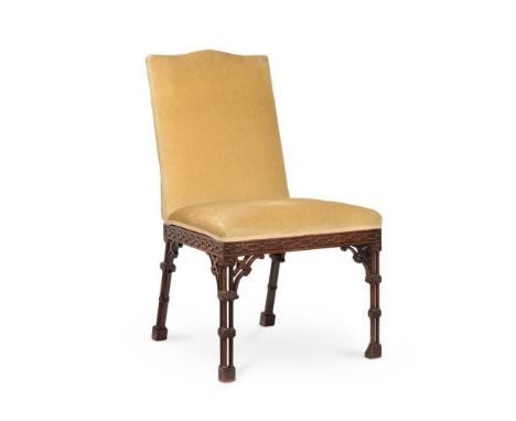 A GEORGE III CARVED MAHOGANY AND UPHOLSTERED SIDE CHAIRIN THE MANNER OF THOMAS CHIPPENDALE, CIRCA 1770The arched back above a