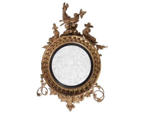 A REGENCY GILTWOOD CONVEX GIRANDOLE WALL MIRRORCIRCA 1815The crest as a hippocampus flanked by dolphins, the arms with cut gl