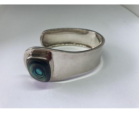 A SILVER DESIGNER BANGLE 