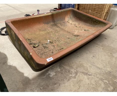 AN UNUSUAL CURVED SALT GLAZED TROUGH BEARING THE NAME 'SALOPIAN ENGERS LTD' 