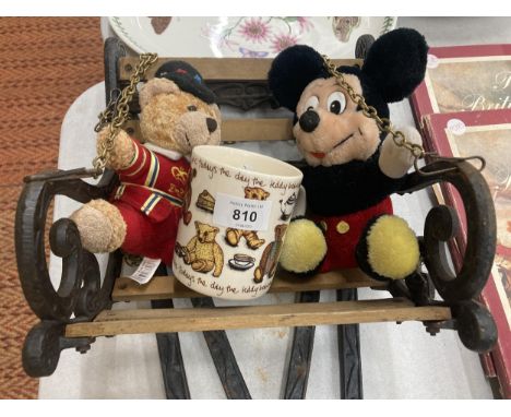 A CAST VINTAGE SMALL SWINGING SEAT WITH STAND PLUS MICKEY MOUSE AND TEDDY PLUSH FIGURES AND A MUG 