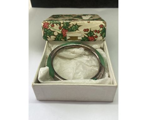 A JADE BANGLE IN A PRESENTATION BOX 