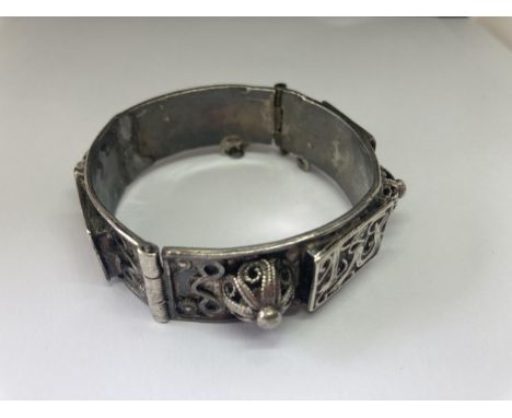 A SILVER EASTERN BANGLE 
