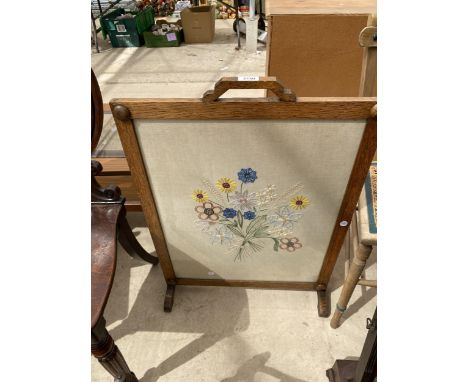 AN OAK FRAMED WOOLWORK FIRESCREEN 