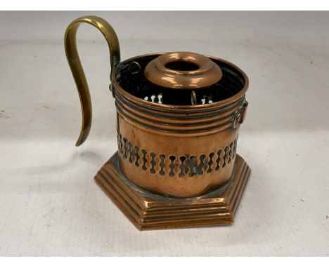 AN ARTS AND CRAFTS COPPER CANDLESTICK WITH BRASS HANDLE WITH TRADE MARK STAMP TO BASE 