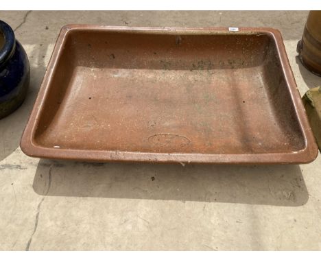 AN UNUSUAL CURVED SALT GLAZED TROUGH BEARING THE NAME 'SALOPIAN ENGERS LTD' 