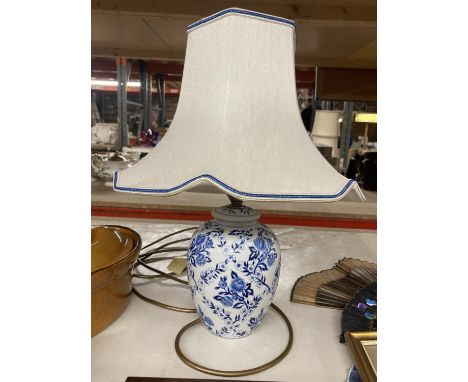 A BLUE AND WHITE CERAMIC TABLE LAMP WITH SHADE PLUS A PORTRAIT PRINT FROM HONG KONG 'NEPALI GIRE' SIGNED IN PENCIL G DOUGLAS 