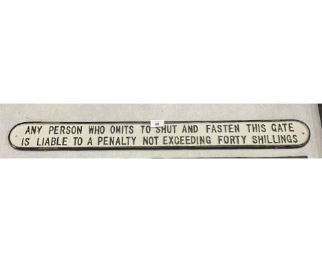 A LARGE CAST 'FASTEN THE GATE' SIGN, LENGTH 82.5CM 