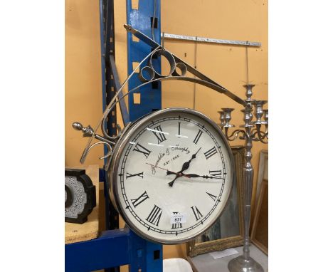 A DOUBLE SIDED WALL CLOCK WITH WALL BRACKET 