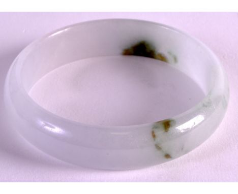 A CHINESE CARVED JADE BANGLE with inclusions. 2.75ins diameter. 