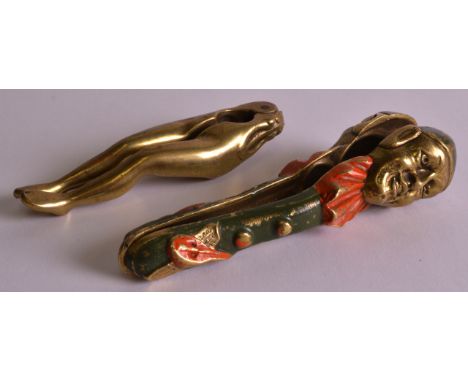 AN UNUSUAL PAIR OF NOVELTY NUT CRACKERS in the form of a pair of legs, together with another nut cracker depicting pierrot. 4