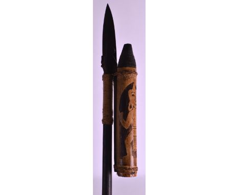 A SOUTH AMERICAN CARVED WOOD SPEAR with blow pipe attachment. 3ft 9ins long. 