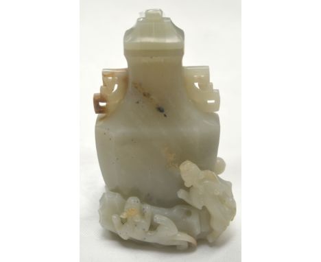 A 19TH CENTURY CHINESE CARVED GREEN JADE VASE AND COVER overlaid with chilong. 12cm high.