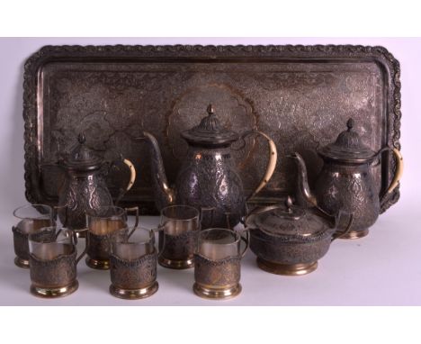 A PERSIAN ENGRAVED SILVER COFFEE SERVICE comprising of coffee pot, teapot, milk jug, sugar basin &amp; six cups &amp; tray. (