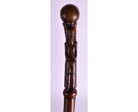 A 19TH CENTURY CARVED EUROPEAN FOLK ART WALKING STICK of naturalistic form, with figural terminals. 3ft 4ins long. 