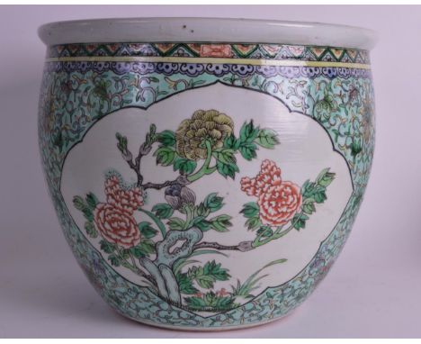 A 19TH CENTURY CHINESE FAMILLE VERTE JARDINIERE Kangxi style painted with floral sprays and motifs. 1ft diameter.