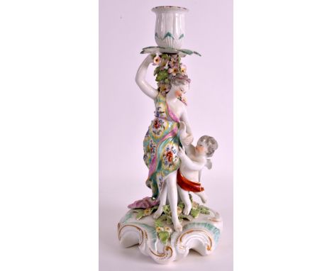 AN 18TH CENTURY DERBY CANDLESTICK FIGURE depicting Venus and Cupid. 11.5ins high. 