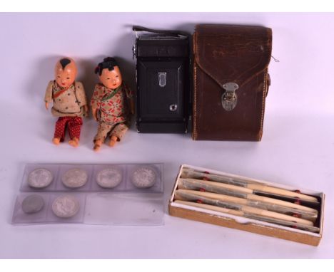 A PAIR OF CHINESE REPUBLICAN PERIOD LACUERED DOLLS together with various South African coins, a camera & ivory handled blades