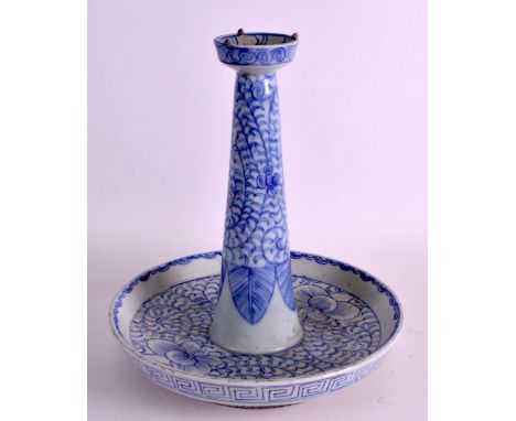 A 19TH CENTURY CHINESE BLUE AND WHITE ALTAR STICK painted with flowers and stylised vines. 10ins high.