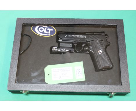 A Umarex 'Colt Defender' CO2 .177 B.B. air pistol, this 'as new' air pistol comes with a Walther red dot sight and a custom d