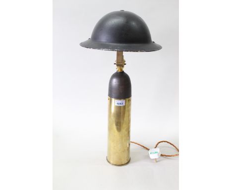 A WWII (dated 1939) 25 lb brass shell case, later crafted into a table lamp with a tin helmet shade