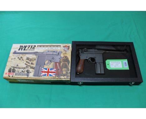 A K.W.C. M712 broomhandle CO2 .177 B.B. air rifle, this 'as new' air pistol comes with custom display case and original box e