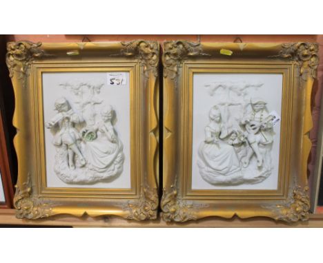 Two ceramic relief portrait panels in gilt frames. (2)