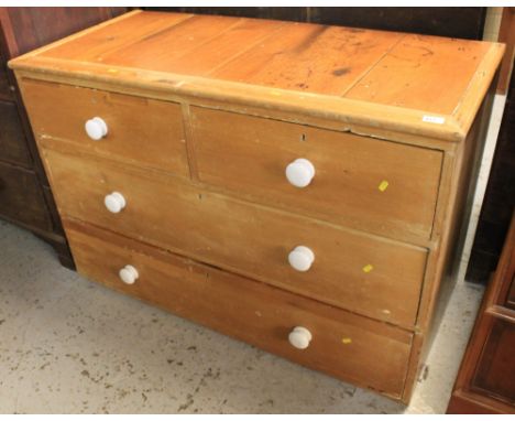 Late 19th/early 20th Century pine straight front chest of two short and two long drawers with ceramic knob handles.