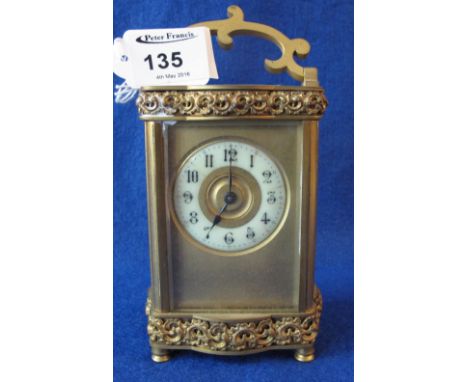 Early 20th Century French gilded brass carriage clock with ceramic dial and Arabic numerals.