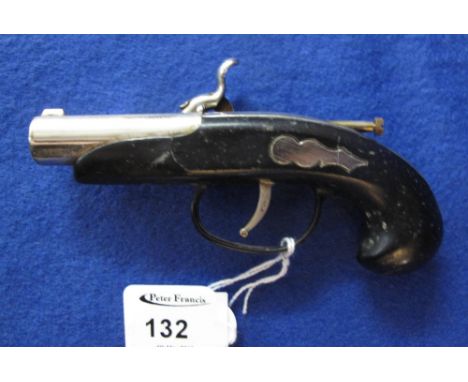 Small table lighter in the form of a hammer action pistol.