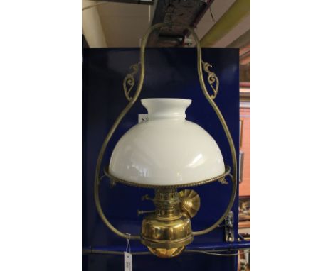 Brass hanging oil lamp with opaque cream shade, marked: 'Lampe Veritas'.