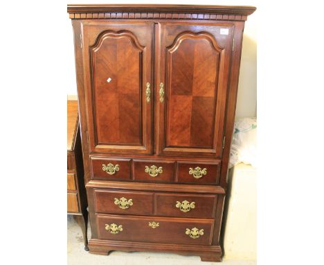 Modern hardwood drinks cabinet with an arrangement of drawers on bracket feet.