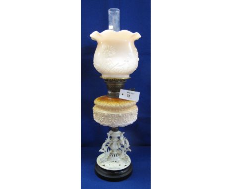 Early 20th Century brass double burner oil lamp with coloured opaline glass relief decorated reservoir on a foliate cast meta