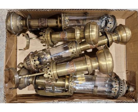 Four brass GWR wall-mounted oil lamps, three are single lights with glass chimneys and finials and one is a double light (lac