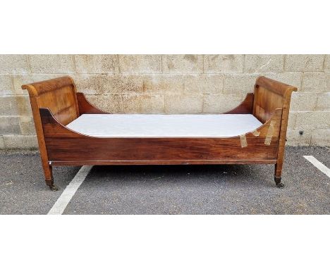 Late 19th/early 20th century Lit Bateau-style single bedstead, the head and footboards with brass caps and castors, 86cm wide