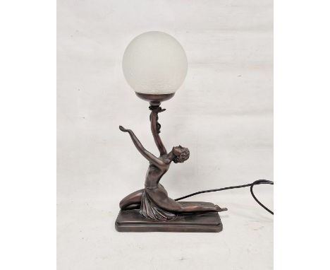 Contemporary Art Deco-style bronzed resin table lamp, with frosted globe shade supported by a scantily draped female dancer o