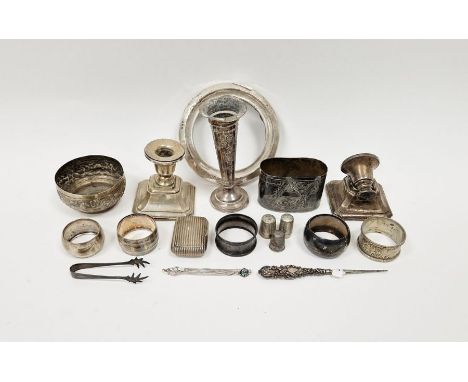 Four silver napkin rings, a pair of silver sugar tongs, silver mounted circular photograph frame and a selection of other met