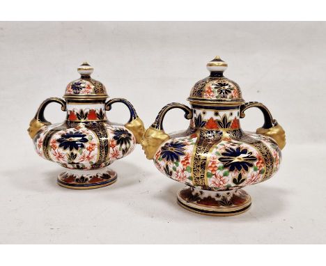 Pair of Crown Derby imari pattern two-handled squat formed vases and domed covers, late 19th century, printed crowned D marks