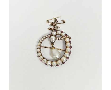 Antique gold-coloured metal, pearl and ruby set serpent brooch, the serpent entwined to form shaped oval, with large baroque-