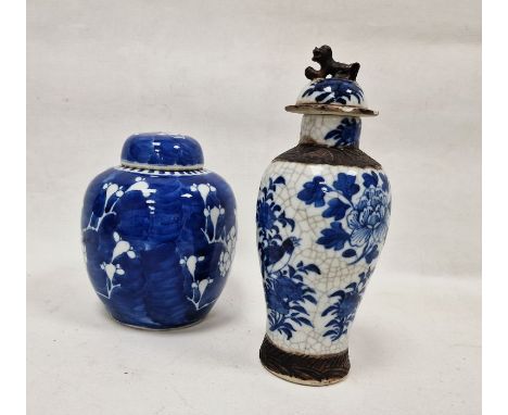 Two Chinese Qing Dynasty vases and covers, the first of inverted baluster form with dog of Fo finial, painted with birds, flo