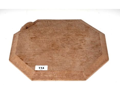 A Robert ‘Mouseman’ Thompson cheese board, with carved mouse figure in relief, 30.5 x 25cms wide.