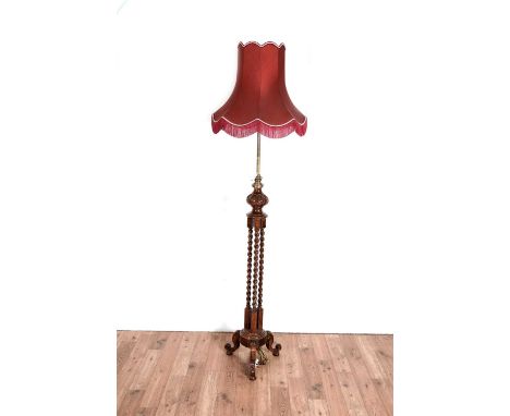 An early 20th Century oak and brass lamp standard, with adjustable brass column and barley twist supports (probably converted