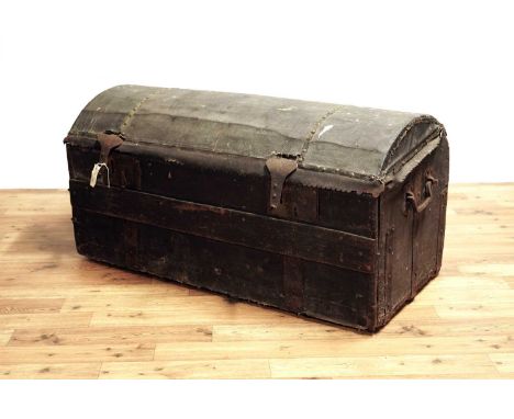 A 19th Century leather and wood bound two handled trunk, the domed cover opening to reveal storage space above fall flap fron