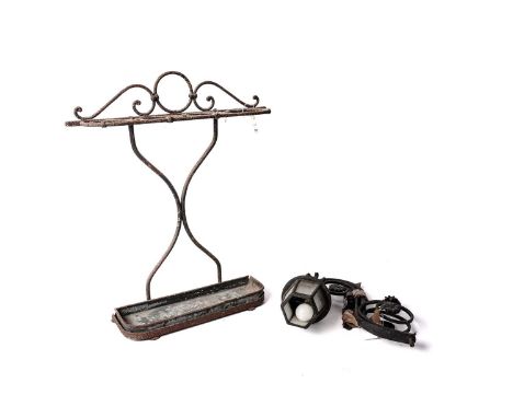 A vintage wrought iron stick stand, with scrolling decoration, fitted with four holders, 62.5cms high; together with a cast i