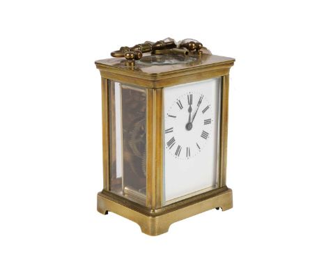A 20th Century brass carriage clock, with white enamel Roman dial, with platform lever escapement, with key, 15cms high (incl