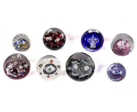A collection of decorative glass paperweights, of various designs, including: a Caithness  ‘G.J. 1952-2002 Royal Crown’; a mi