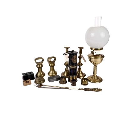 A 19th Century brass oil lamp, with clear glass funnel, white glass shade, and brass reserve, raised on a stepped circular ba