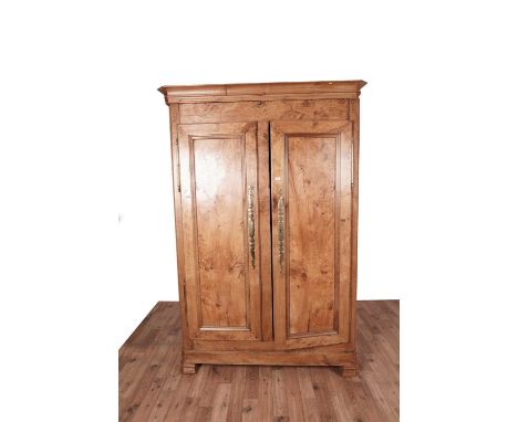 A large fruitwood armoire in an early 19th Century French provincial style, fitted with a pair of long doors opening to revea