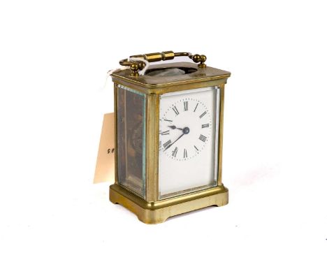 A 20th Century brass carriage clock, with white enamel Roman dial, with platform lever escapement, 14.5cms high (including ha