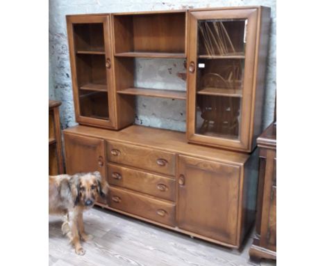 An Ercol golden dawn sideboard with glazed cabinet top, width 155cm, depth 44cm &amp; height 162cm.  